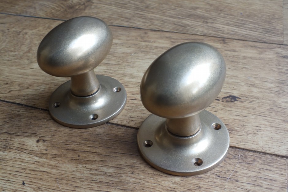 Aged Brass Oval Door Knobs on Round Rose